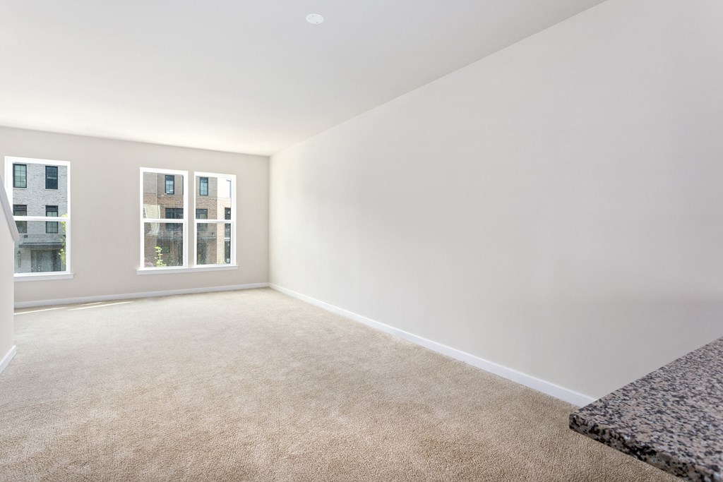 a bedroom with white walls and carpet