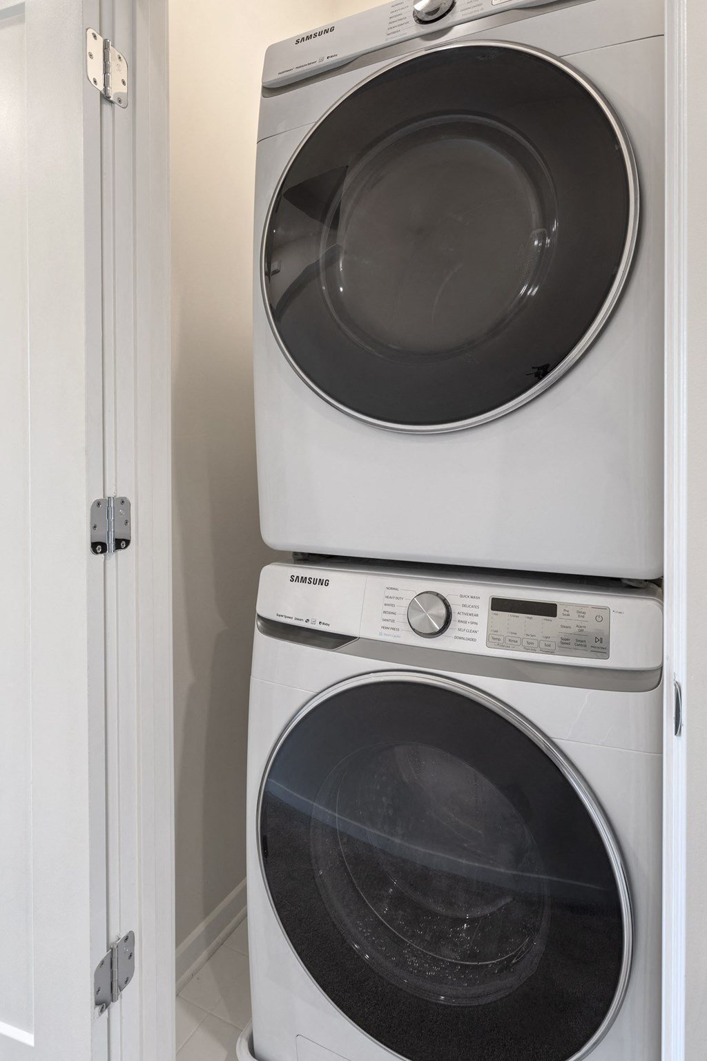 a washer and dryer stacked on top of each other in a laundry room