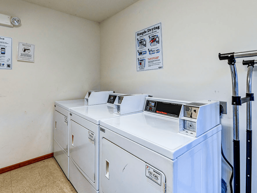 a laundry room with two washes and two washing machines