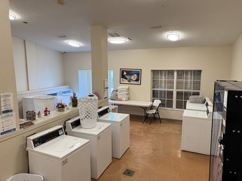 A laundry room with washers and dryers.
