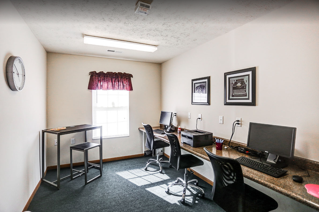 a home office with a computer and a desk