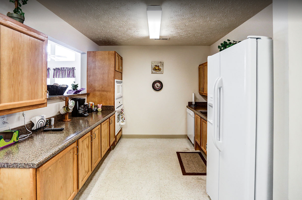 a kitchen with wooden cabinets and a white refrigerator