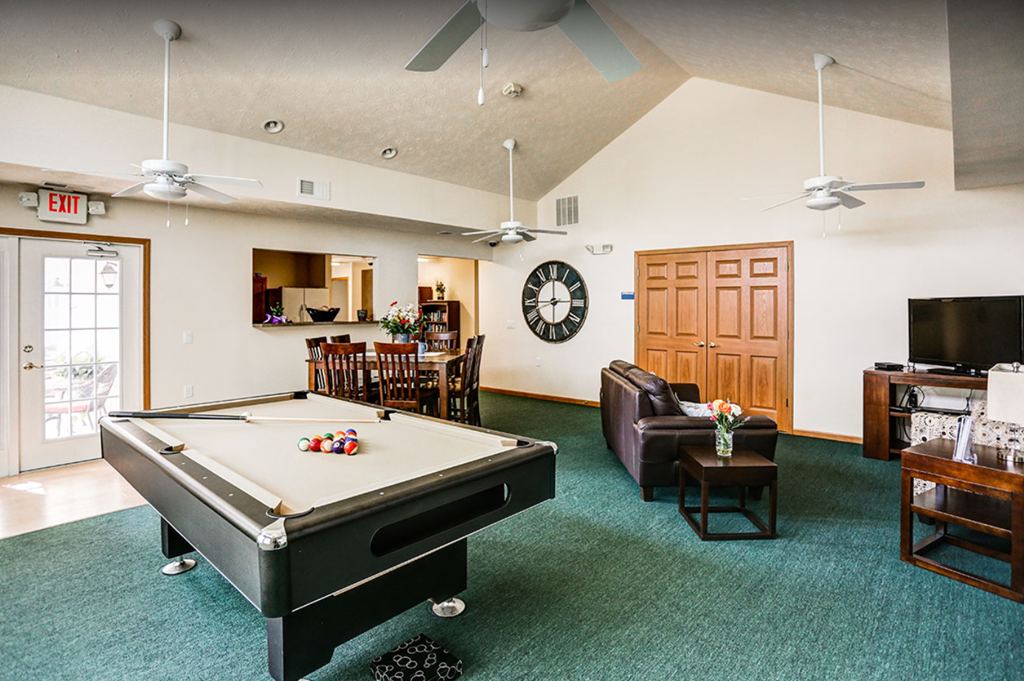 a game room with a pool table and a tv