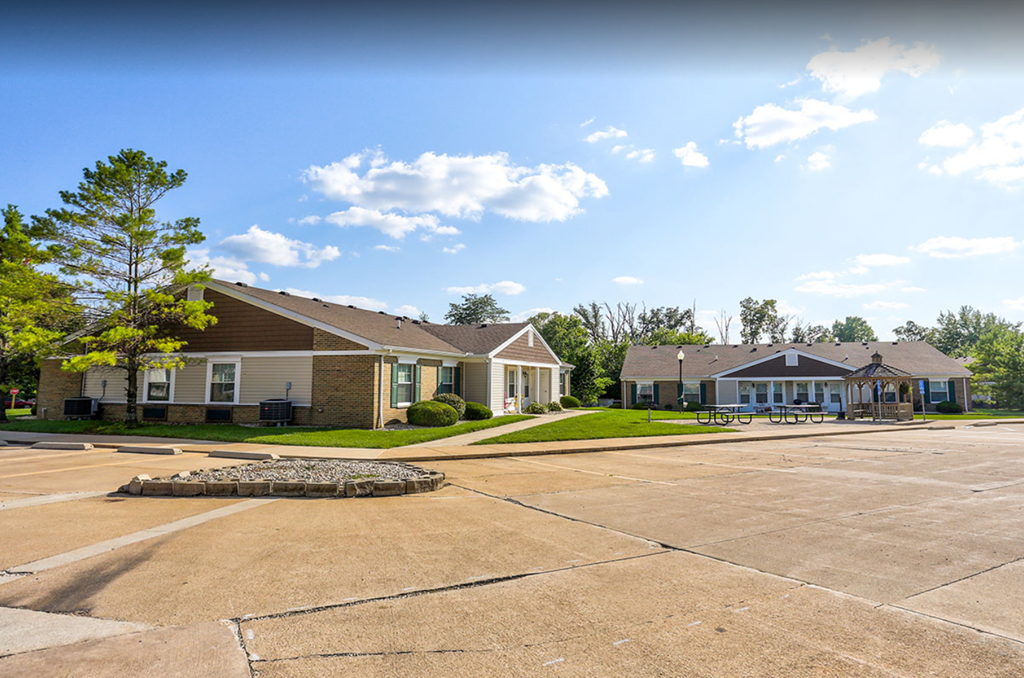 an empty parking lot in front of two houses