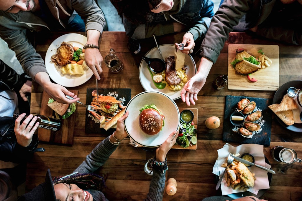 people sitting around a table eating food