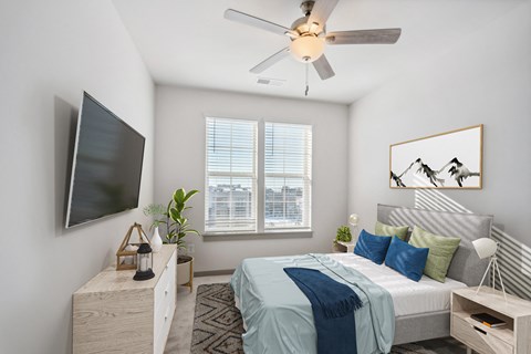 a bedroom with a large bed and a ceiling fan