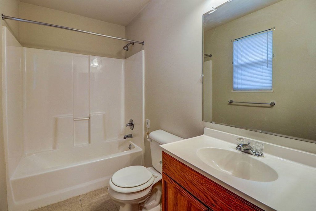 a bathroom with a sink toilet and a bath tub