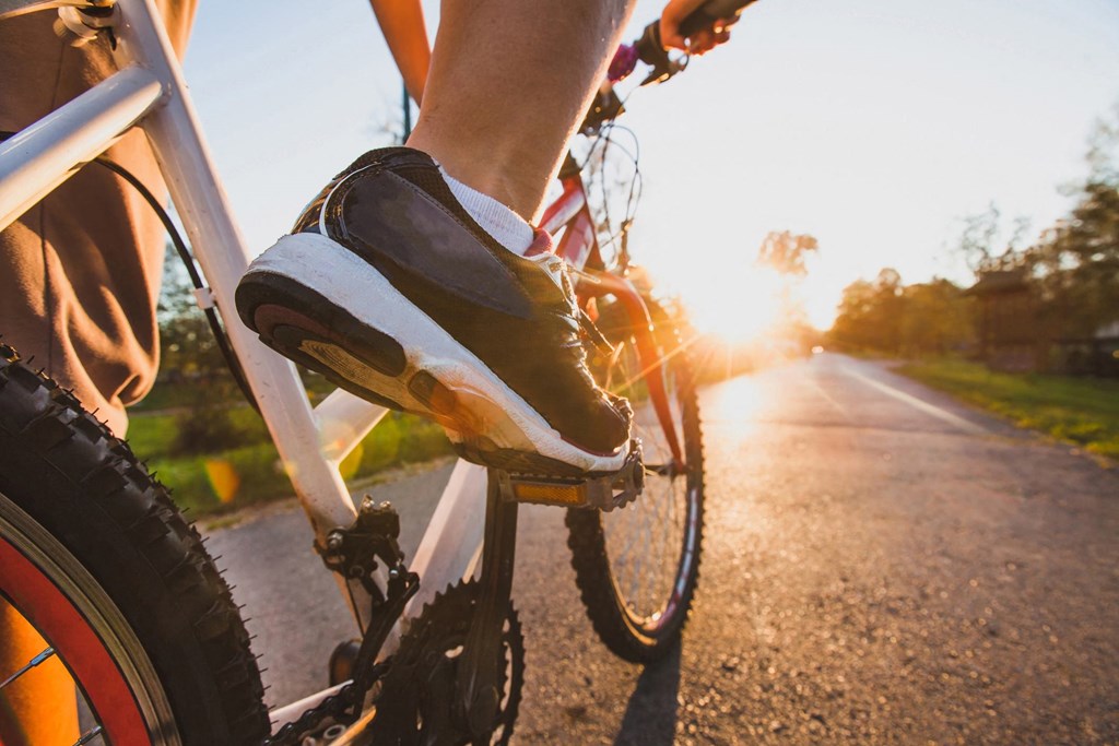 A person is riding a bicycle on a road.