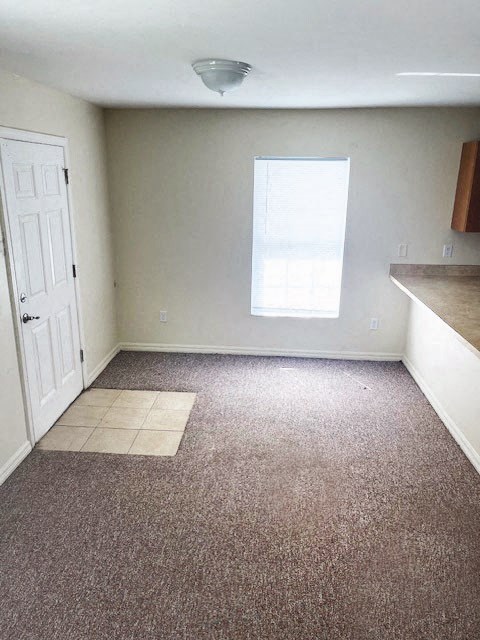 an empty room with a door and a window