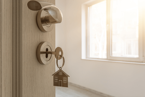a door with a keychain with a house shaped door knob on it