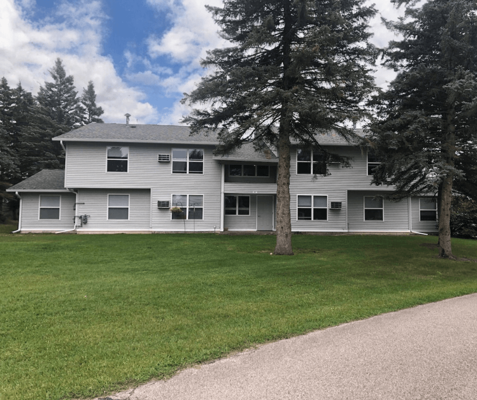a large white house with trees in front of it
