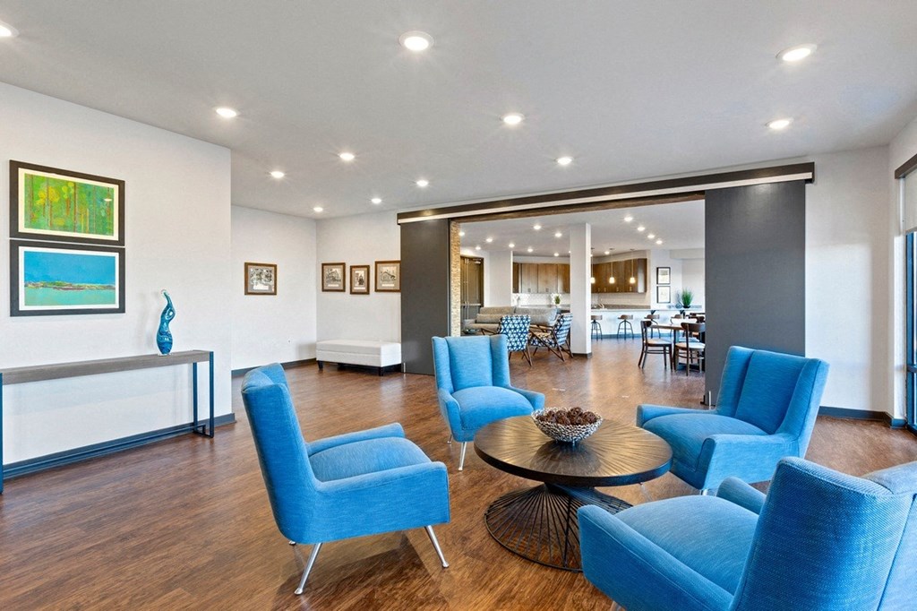 the preserve at ballantyne commons living room with blue chairs and a table