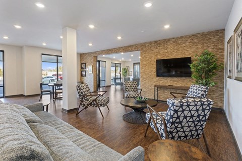 a living room with a couch and chairs and a television
