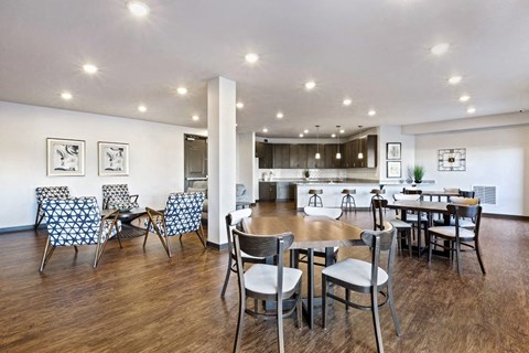 a dining room and kitchen with a table and chairs
