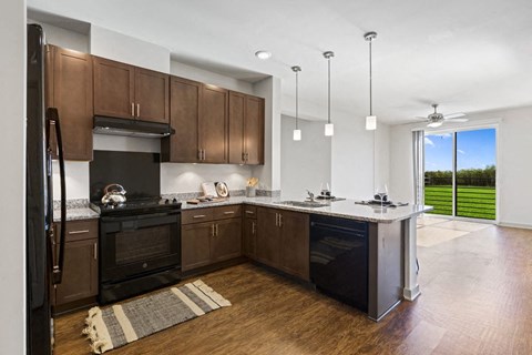 a large kitchen with wooden cabinets and black appliances