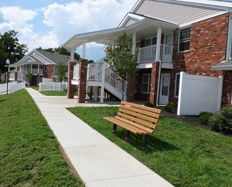a wooden bench in front of a building
