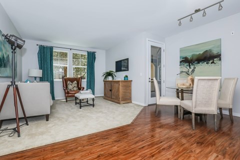 A living room with wooden floors and furniture.