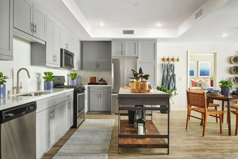 A modern kitchen with a dining table and chairs.