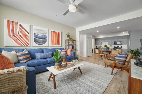 A living room with a blue couch and a coffee table.
