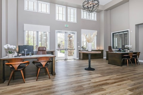 A modern office space with wooden floors and furniture.