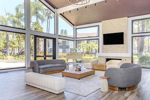 A modern living room with a fireplace and a large window.
