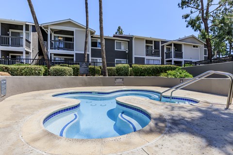 A swimming pool in front of apartment buildings.