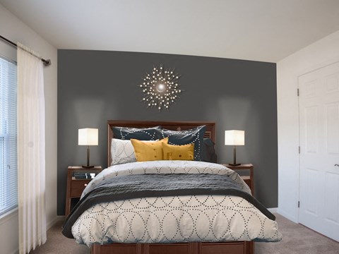 A bedroom with a large bed and a chandelier.