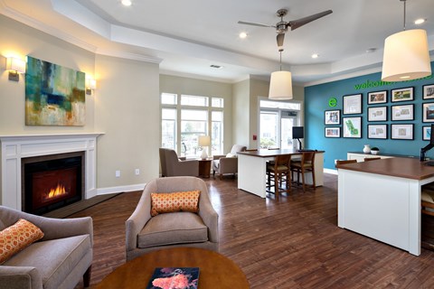 A living room with a fireplace and a painting on the wall.
