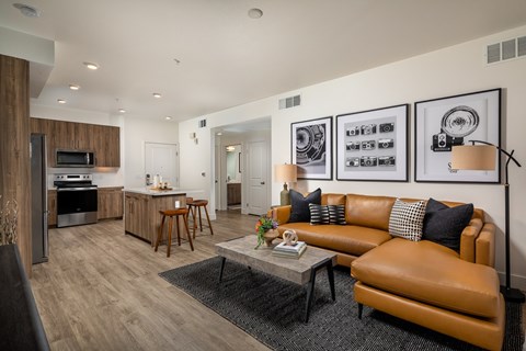 A modern living room with a brown leather couch and a coffee table.