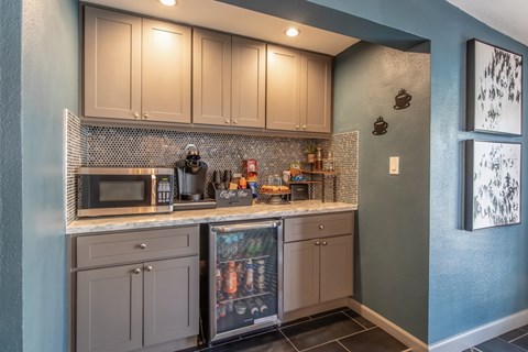 A kitchen with a blue wall and a fridge with a picture of a family on it.