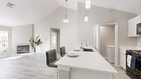 A modern kitchen with a dining table and chairs.