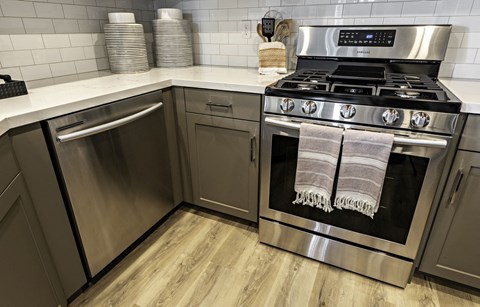 A modern kitchen with a stainless steel oven and dishwasher.