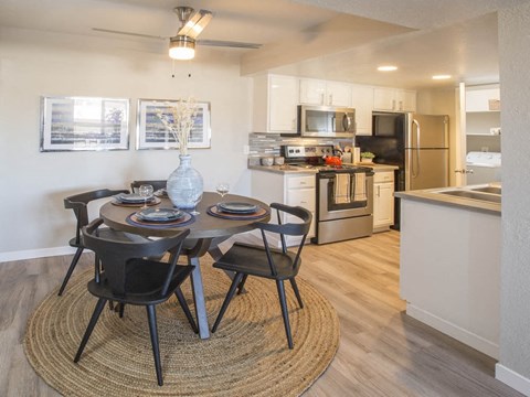 A modern dining room with a round table and chairs.