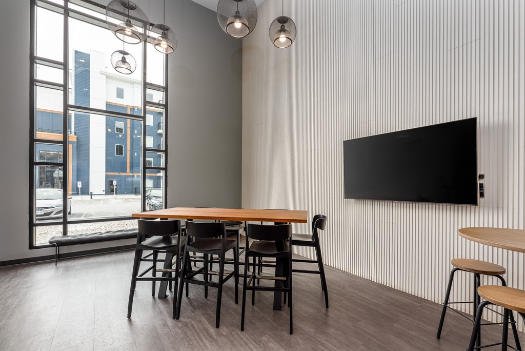 a dining room with a table and chairs and a tv