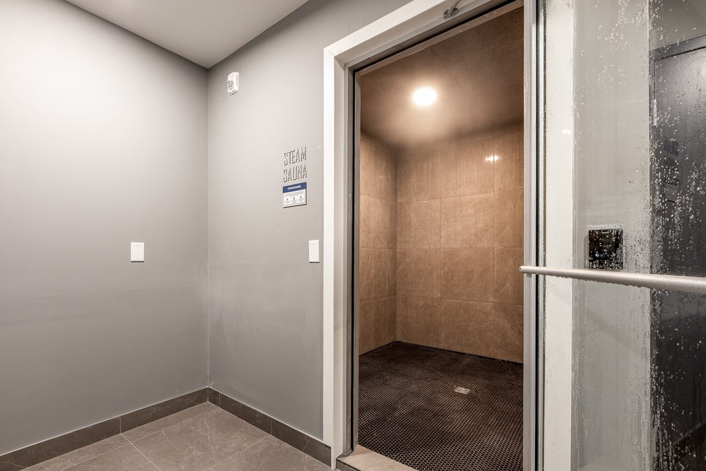 a bathroom with a shower and a sliding glass door