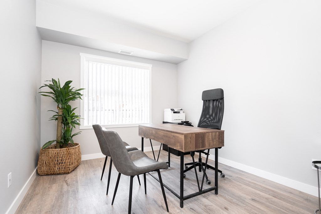 a home office with a desk and two chairs