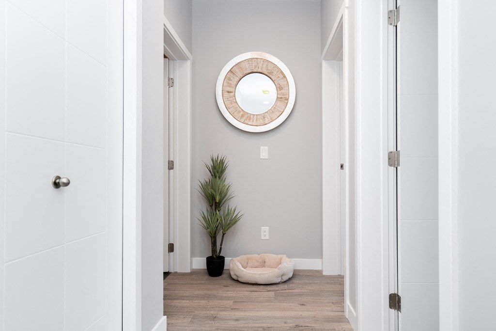 a view of a hallway in a 555 waverly unit with a round mirror on the