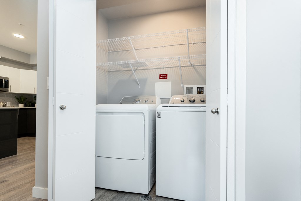 a washer and dryer in a laundry room at the enclave at woodbridge apartments in