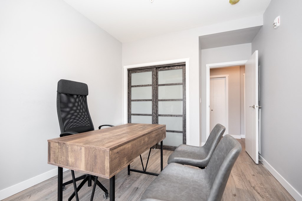 a room with a desk and two chairs