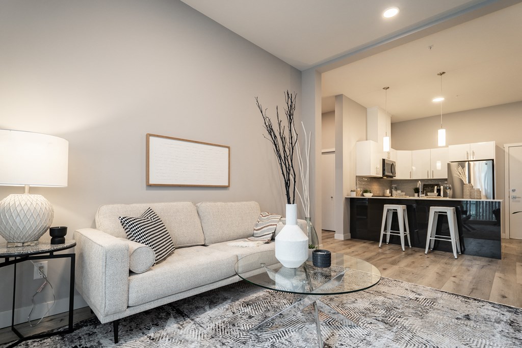 a living room with a couch and a glass table