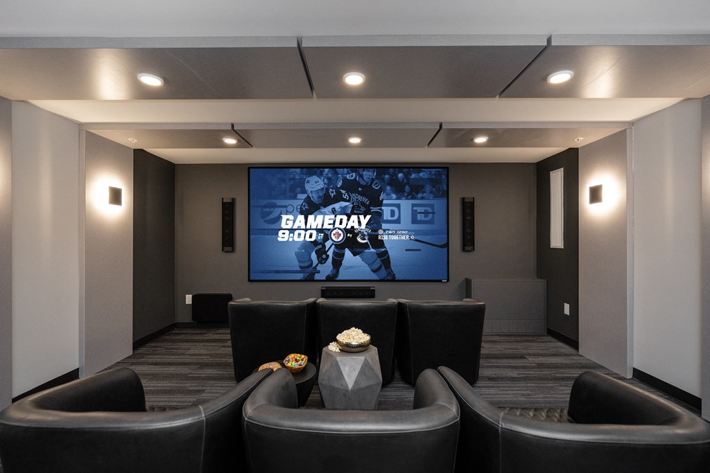 a living room with couches and a tv in front of a screen