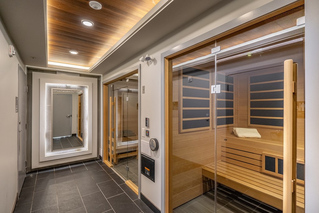 a sauna and steam room in a home with a glass door