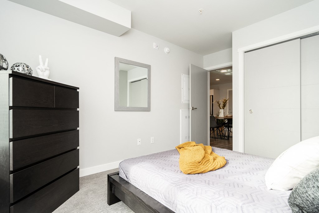 a bedroom with a large bed and a dresser