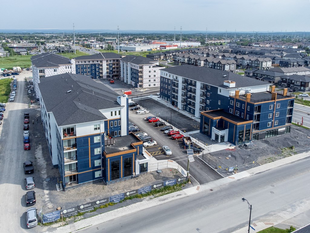 an aerial view of a new apartment complex with cars parked in a parking lot