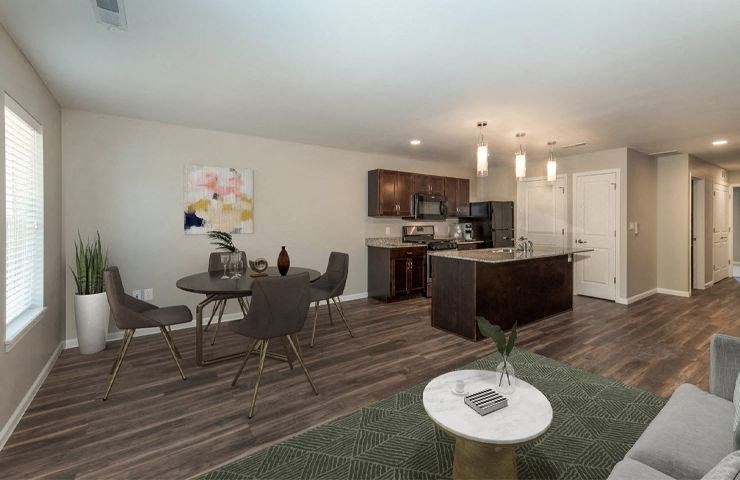 a living room and kitchen with a table and chairs