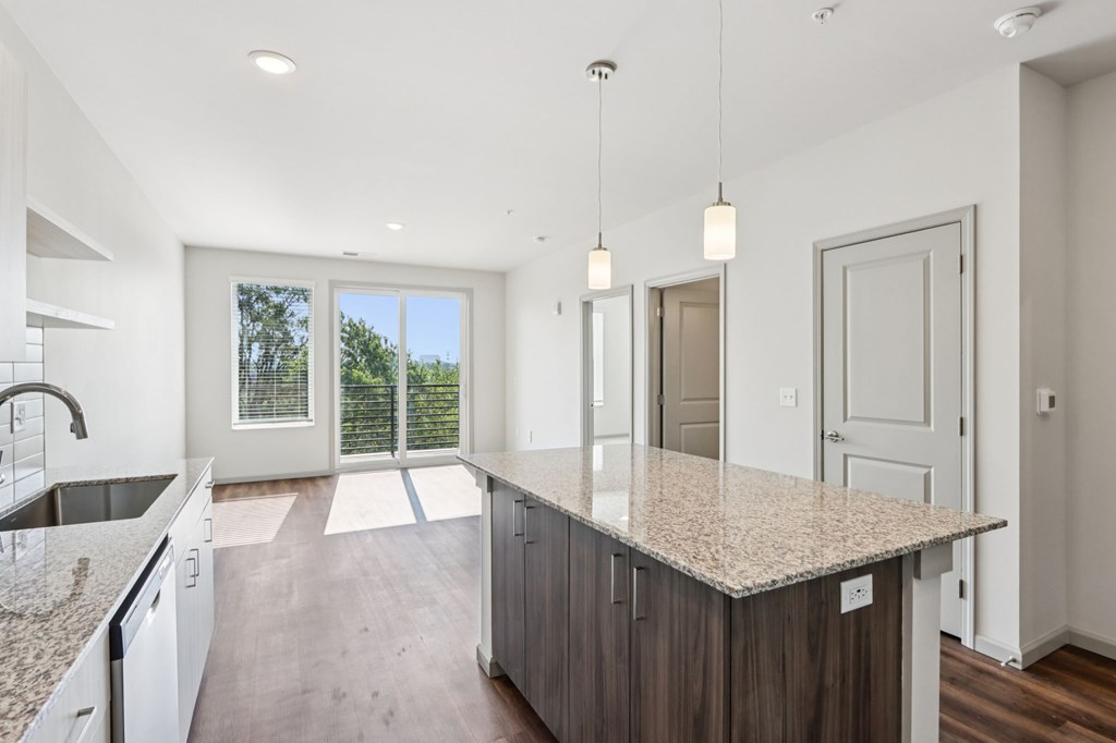 A kitchen with a granite countertop and a sink.