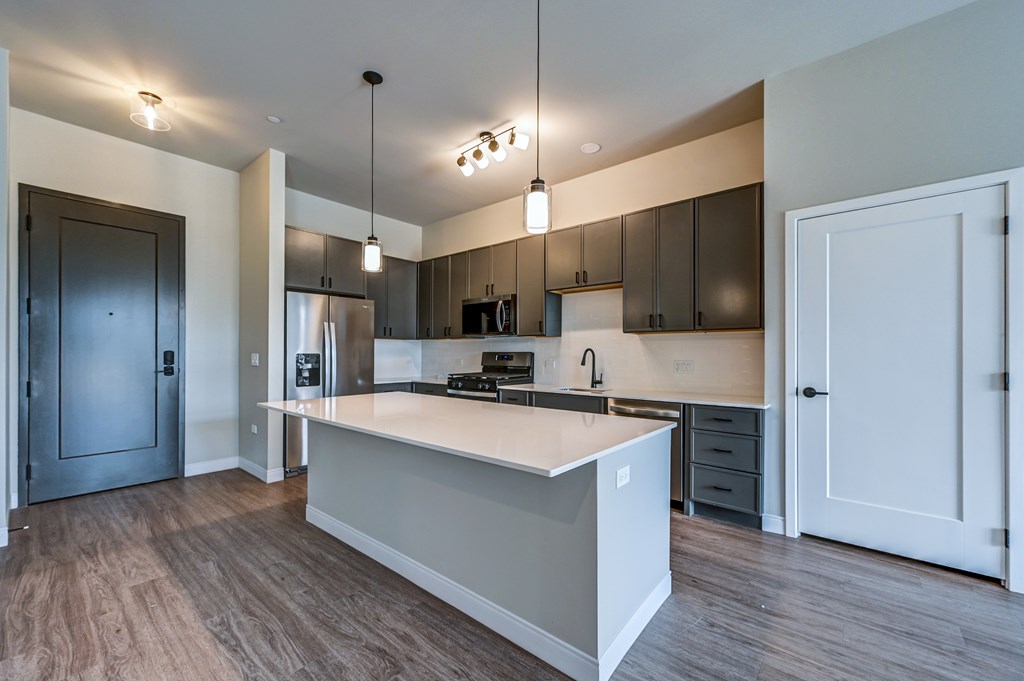A modern kitchen with a large island in the center.