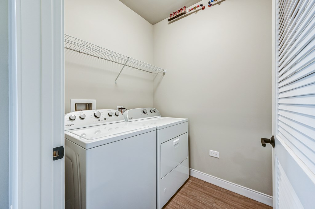 A white washer and dryer in a small laundry room.