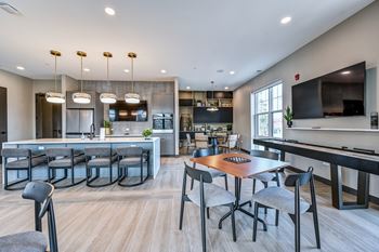 A modern kitchen with a dining table and chairs.