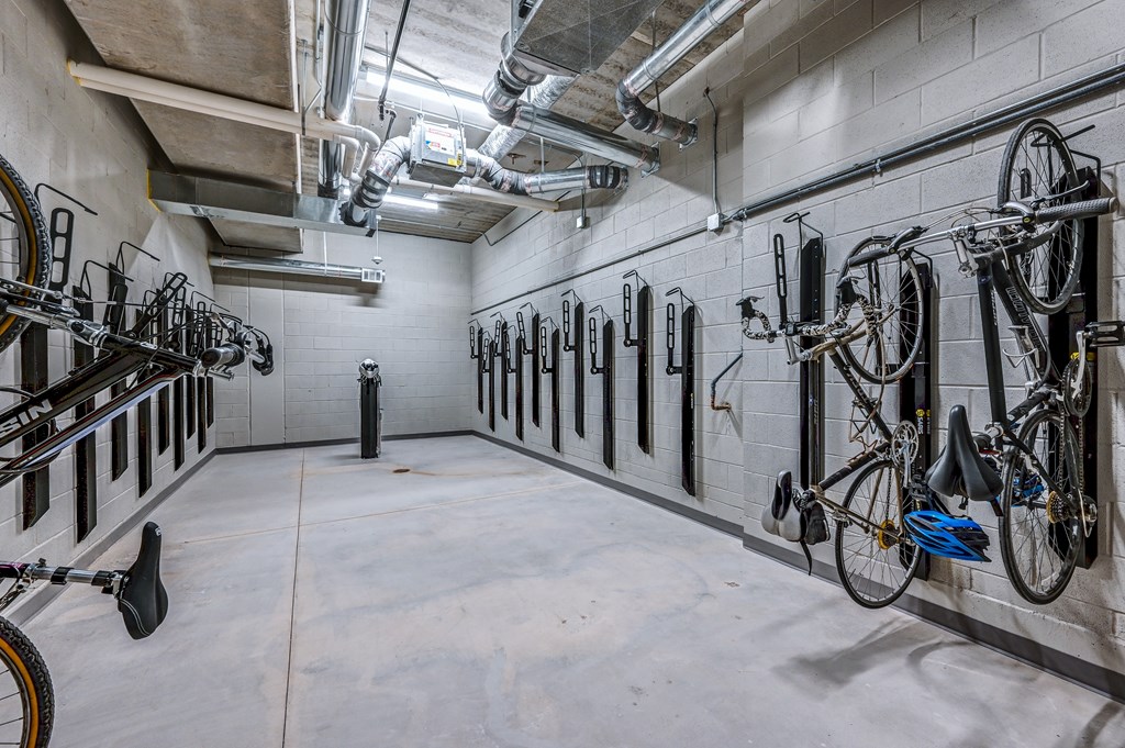 A bike parking area with bikes on the wall.